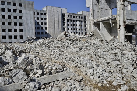 The remains of the destroyed building of a large industrial facility. Background.
