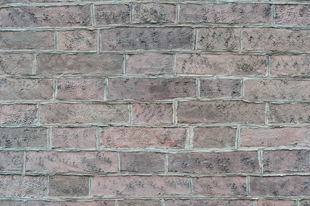 A wall with an ornament of a solution of each brick of an ancient building of pastel brown red muted...