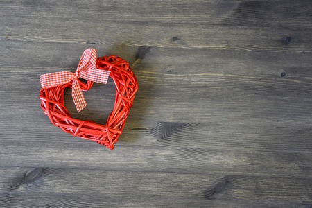 Heart red on wooden vintage background. Romantic card concept. The view from the top. Flat lay.の写真素材