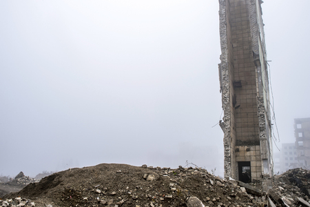 The remains of the wall of a large destroyed building against the background of other destroyed...