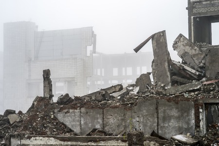 The remains of the destroyed building in the form of piles and a blockage of a pile of stones on the...