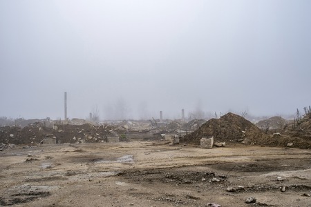 The remains of a large concrete building in the misty haze in the form of fragments of piles and piles of stones. The impact of the destruction. Background.の写真素材