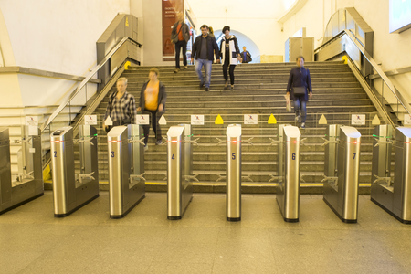 Blur. People go to the passage through electronic turnstiles at the metro station in St. Petersburg, Russia, September, 2018.のeditorial素材