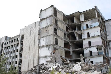 A pile of gray concrete debris with the remains of a large destroyed building. Backgroundの写真素材
