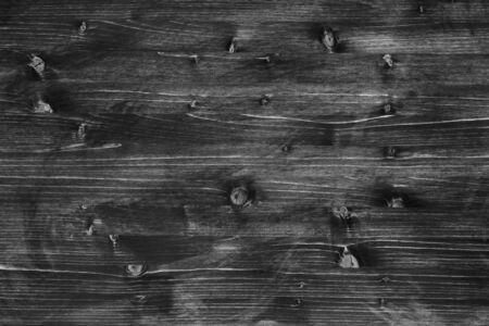 Shabby wooden rustic textured black background with light streaks.の写真素材
