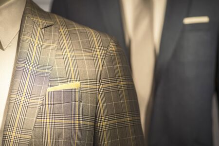 Part of the men's jacket in a cage in warm colors combined with a tie and shirt.の写真素材