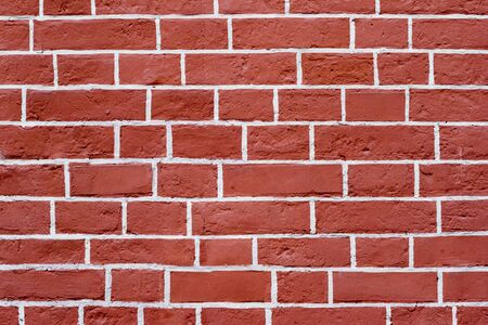 The brick wall is red with white joints. Textured background.の写真素材