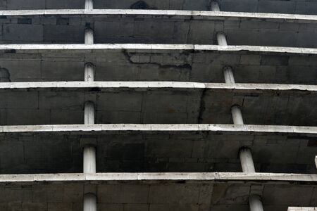 Floors of a large gray concrete building without external walls. Textured background.の写真素材