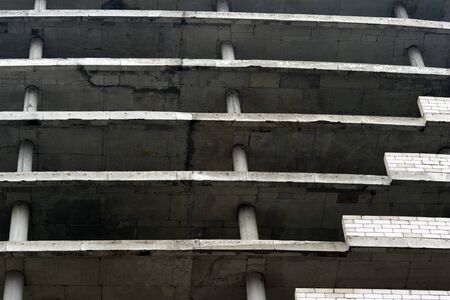 Floors of a large gray concrete building without external walls. Textured background.の写真素材