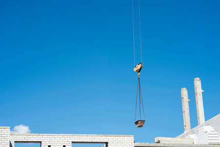 Feed the bowl solution crane in the construction of a brick house. No body.の写真素材