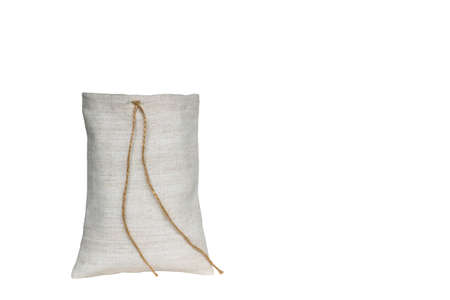 Pouch made of white linen fabric with ties cut out on a white background. The concept of natural materials.の写真素材