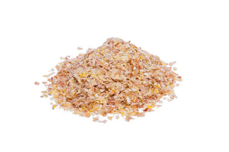Corn bran is stacked in a pile on an isolated white backgroundの写真素材