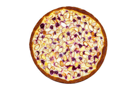 Pie with a golden crust, cottage cheese cream and cherries decorated with almond slices, isolated on a white background. The concept of making a healthy dessert.の写真素材