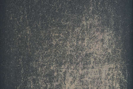 A worn drawing board with a rough surface with remnants of black paint. background.の写真素材