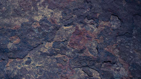 The dark rough texture of the stone with peeling rusty fragments. background.の写真素材