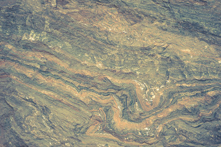 The texture of the stone is blue-green with orange streaks. backgroundの写真素材