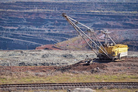 Walking excavator, railway track on the background of part of the iron ore quarry. background. Copy the space.の写真素材