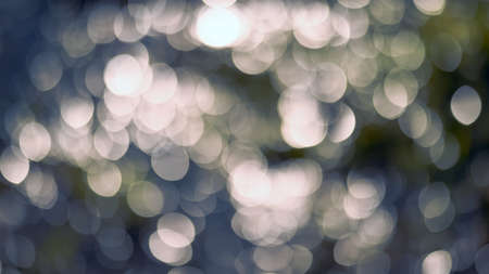 Glowing bokeh in the shape of an ellipse on a muted blue and yellow background. background.の写真素材