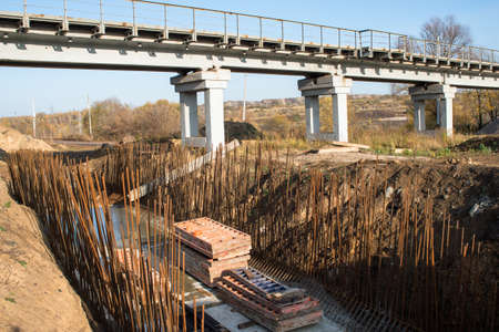 Construction of the concrete Foundation of the support next to the bridge, preparation of the frame for pouring concrete. background.の写真素材