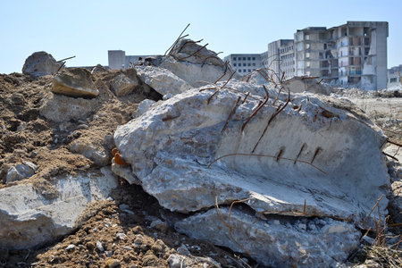 The destroyed beam with the protruding armature lies in the foreground. Backgroundの写真素材
