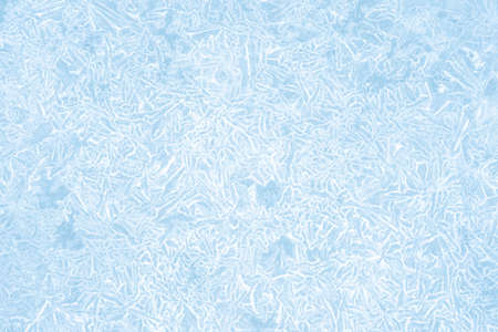 Pale blue ice in a white figured frost pattern. Natural background