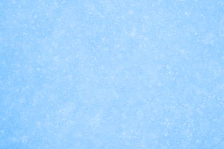 The clear surface of blue ice in light frost and thawed irregularities. Backgroundの写真素材