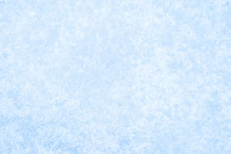 Pale blue ice is textured with a luminous curly pattern in white frost. Backgroundの写真素材