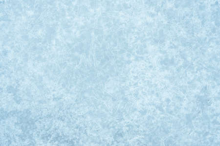 Pale gray-blue ice is textured with a luminous curly pattern of ice veins in white frost. Backgroundの写真素材