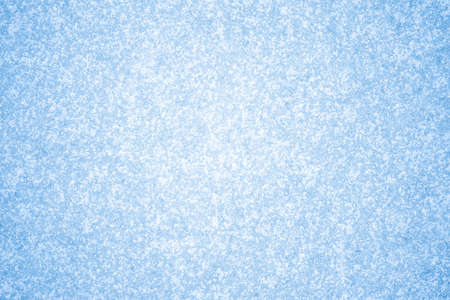 Snow-covered white frost pattern with natural illumination on blue ice. Backgroundの写真素材