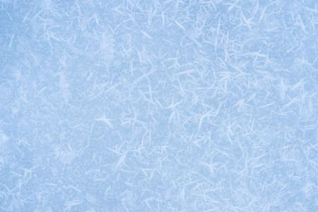 Ice blue with textured white frost on a flat surface. background.の写真素材