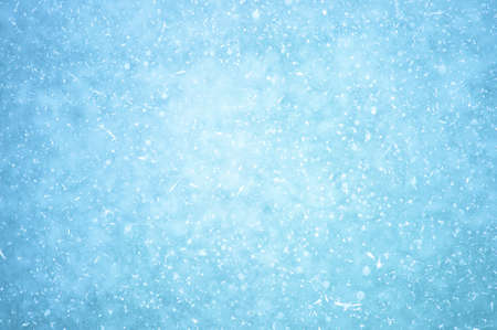 Glowing naturally blue ice with a haze effect with white patches of frost and frozen air bubbles. background.の写真素材