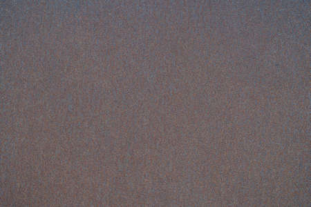 Rusty dark metal sheet with uniform corrosion in uniform lighting. background.の写真素材