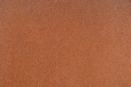 Rusty metal sheet with uniform orange corrosion in uniform lighting. background.の写真素材