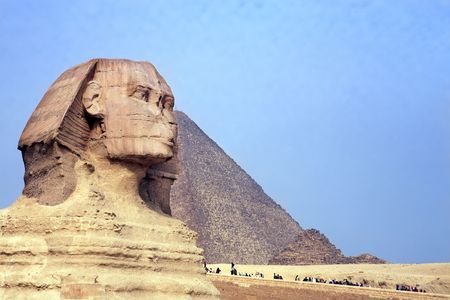 view of the sphynx with the pyramids of gizah near cairo in egypt