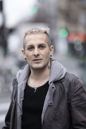 portrait of a caucasian man with piercing and tattoos
