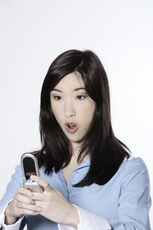 studio shot isolated portrait of a young cute asian woman calling by phoneの写真素材