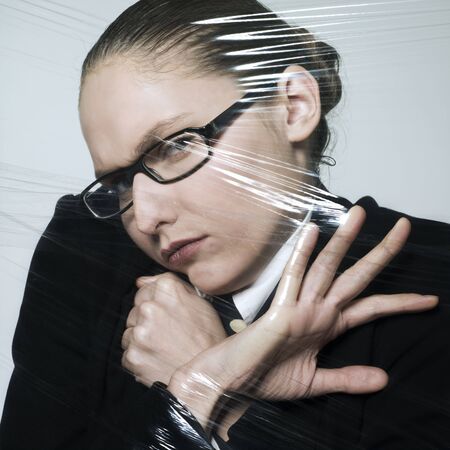 studio shot portrait of a beautiful young woman in a costume suit stressed by lifeの写真素材