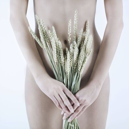 studio shot picture of a young beautiful breast naked caucasian woman holding graiの写真素材