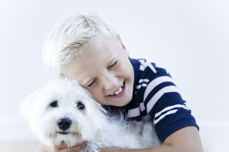 portrait of a smart caucasian expressive kid on idoor isolated backgroundの写真素材