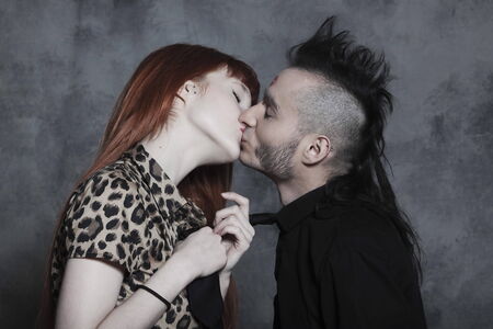 cute young caucasian couple urban style loving each other on isolated backgroundの写真素材