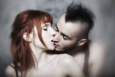 cute young caucasian couple urban style loving each other on isolated backgroundの写真素材