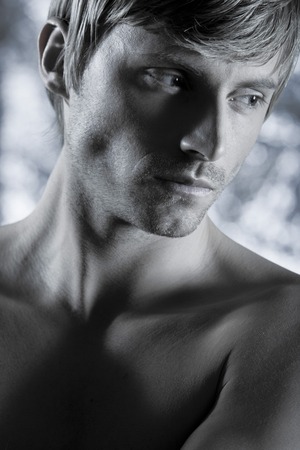 studio portrait of handsome blond man torso naked doing workoutの写真素材