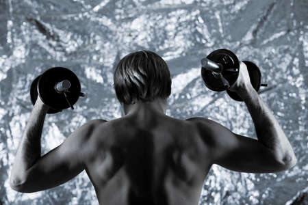 studio portrait of handsome blond man torso naked doing workout