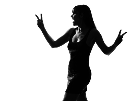 stylish sexy silhouette caucasian beautiful woman laughing peace victory gesture on studio isolated white backgroundの写真素材