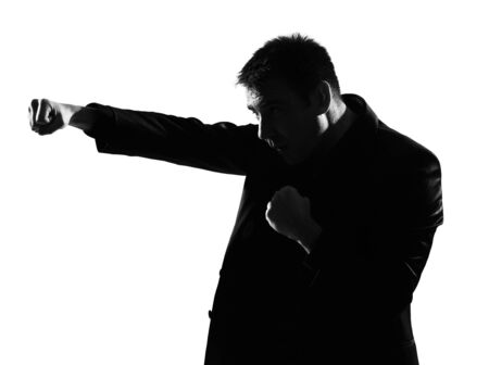 silhouette caucasian business man boxing gesture  expressing behavior full length on studio isolated white backgroundの写真素材