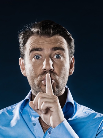caucasian man unshaven hush sign portrait isolated studio on black backgroundの写真素材