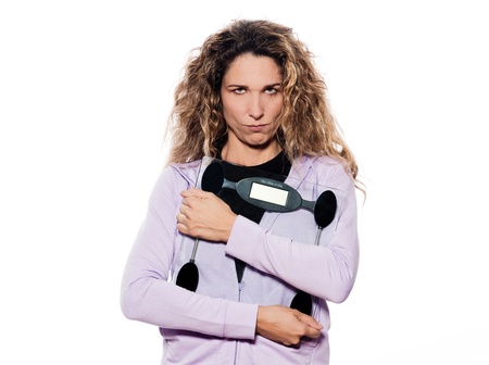 caucasian woman hold scale sullen portrait isolated studio on white backgroundの写真素材