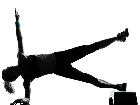 one woman exercising workout fitness aerobic exercise abdominals push ups posture on studio isolated white backgroundの写真素材