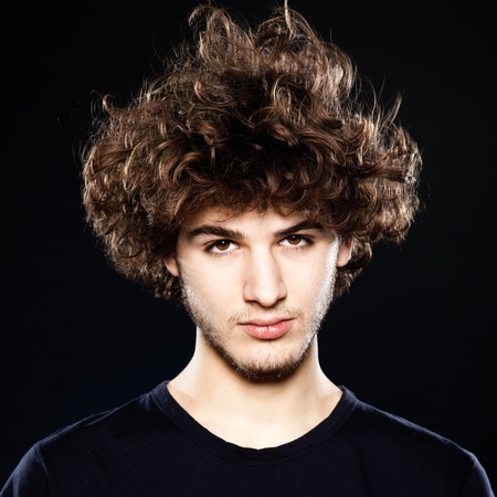 studio portrait of a cool young man on black backgroundの写真素材