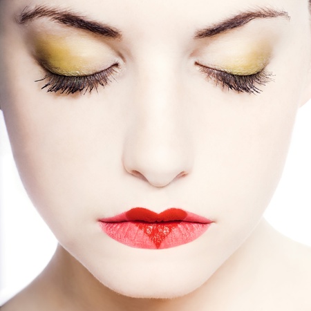 young beautiful caucasian woman playing with heart drawing on lipsの写真素材